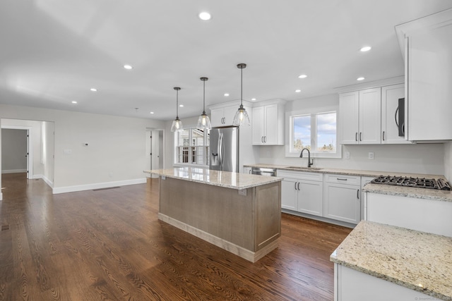 kitchen featuring dark wood-style floors, stainless steel fridge, white cabinetry, and a sink