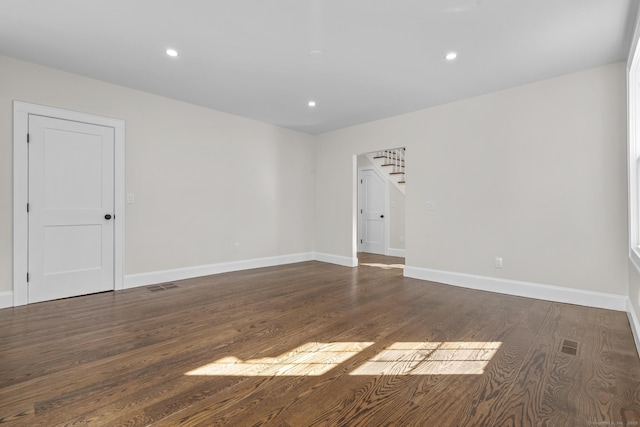 spare room with visible vents, recessed lighting, baseboards, and wood finished floors