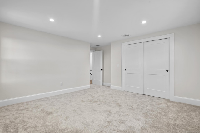 unfurnished bedroom featuring a closet, carpet flooring, recessed lighting, and baseboards