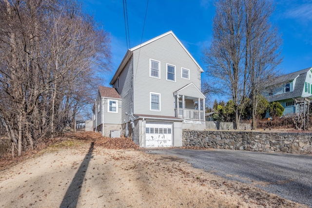 view of front of home with a porch and a garage