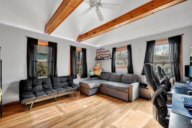 living room with a ceiling fan, light wood-style flooring, and vaulted ceiling with beams