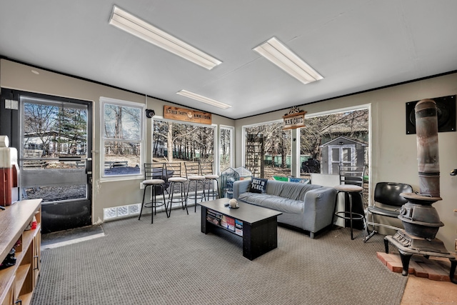 carpeted living area with vaulted ceiling and a sunroom