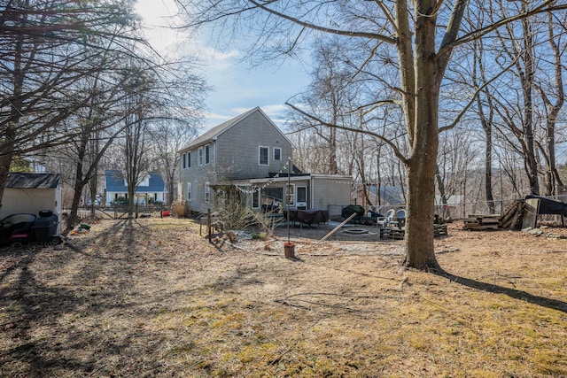 back of property featuring a patio and fence