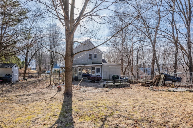 view of yard featuring fence, an outdoor structure, and a shed