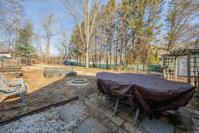 view of patio featuring fence and an outdoor fire pit