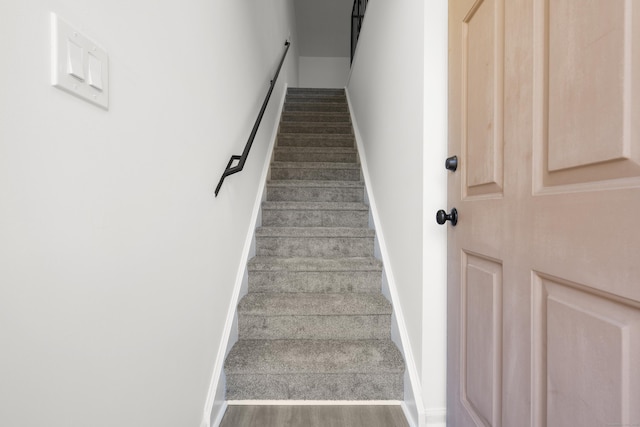 stairs with baseboards and wood finished floors