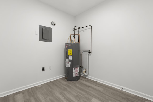 utility room featuring electric panel and electric water heater