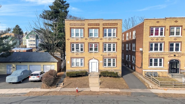 view of front of property featuring brick siding and a garage