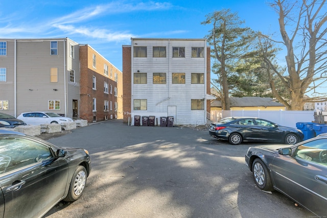 view of front of property featuring uncovered parking and fence