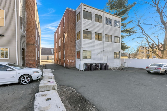 exterior space with brick siding and fence