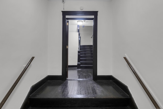 stairway with baseboards and hardwood / wood-style floors