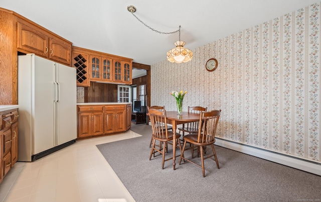 dining area featuring wallpapered walls and a baseboard radiator