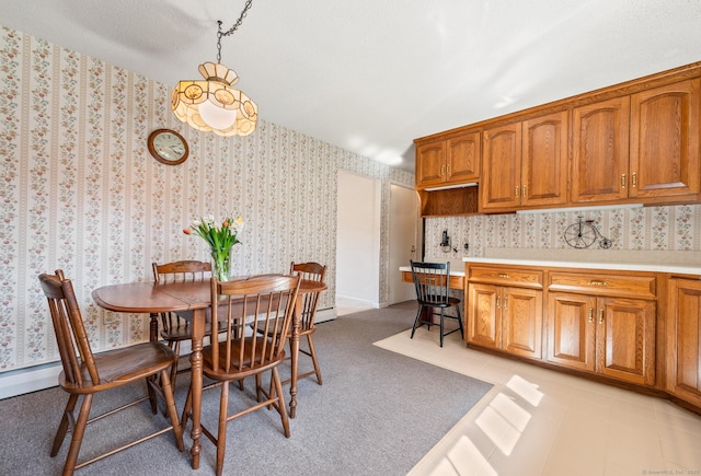 dining room featuring light carpet and wallpapered walls