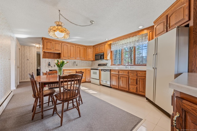 kitchen with a baseboard heating unit, wallpapered walls, a textured ceiling, white appliances, and light countertops