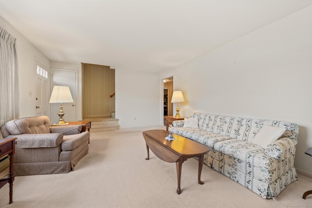 living room featuring stairs and carpet