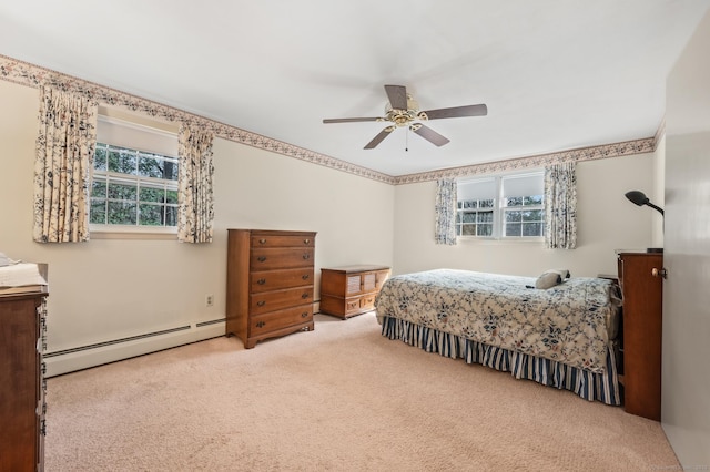 carpeted bedroom with a ceiling fan and baseboard heating