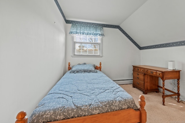 bedroom with vaulted ceiling, a baseboard heating unit, and carpet floors