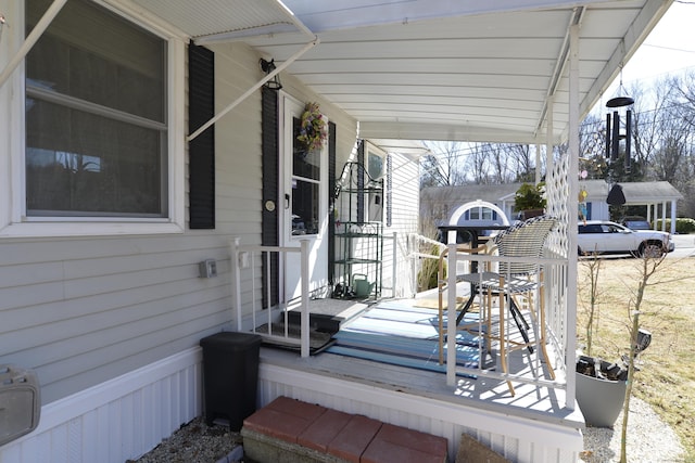 deck with a carport and covered porch