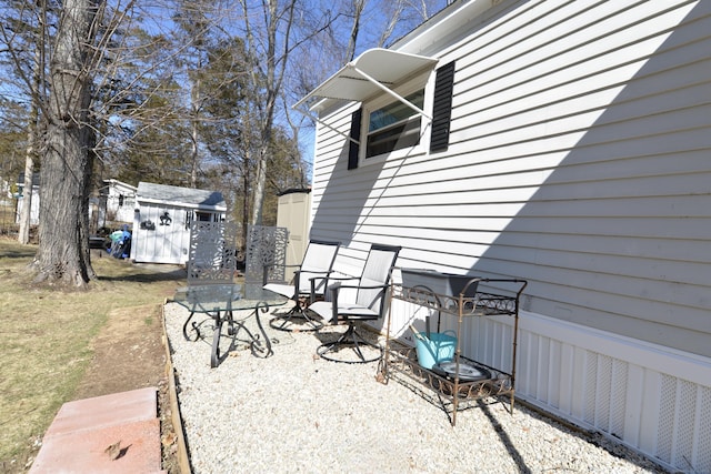 view of patio featuring a storage unit and an outdoor structure