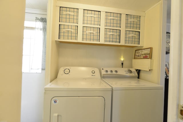 clothes washing area featuring washer and dryer