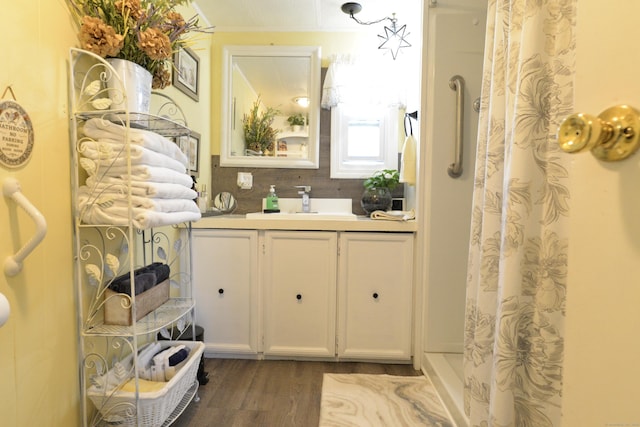 full bath with vanity, a shower with curtain, and wood finished floors