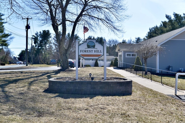 community sign featuring fence