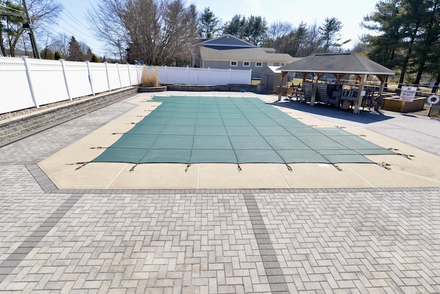 view of swimming pool featuring a gazebo, a fenced in pool, a patio, and a fenced backyard