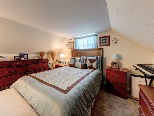 bedroom with carpet floors and vaulted ceiling