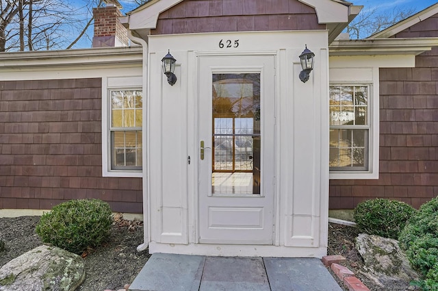 entrance to property featuring a chimney