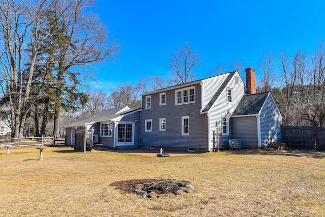 back of house with a patio, fence, a yard, a chimney, and a fire pit