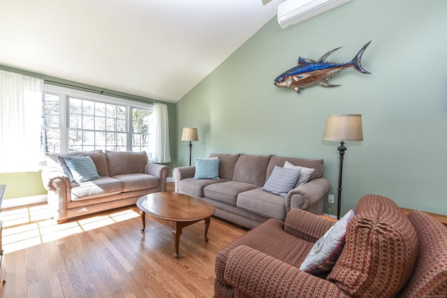 living area featuring a wall mounted air conditioner, high vaulted ceiling, and light wood finished floors