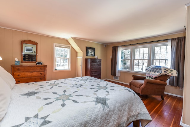 bedroom featuring visible vents, crown molding, baseboards, and wood-type flooring