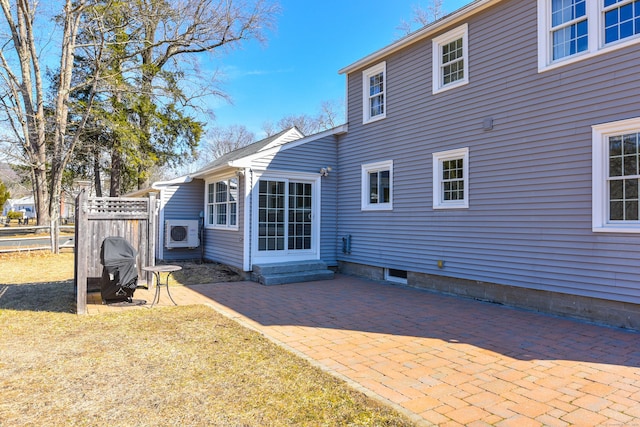 rear view of house featuring a patio and fence