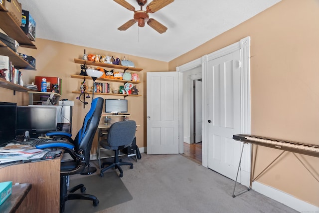 office area with a ceiling fan, baseboards, and carpet floors