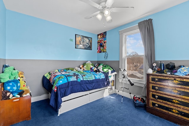 carpeted bedroom featuring baseboards and a ceiling fan