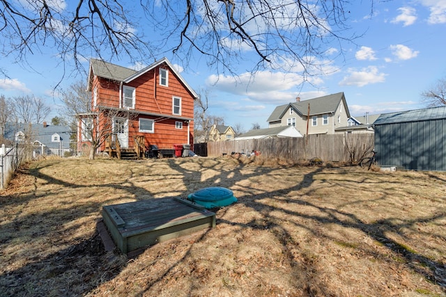 exterior space with entry steps and a fenced backyard