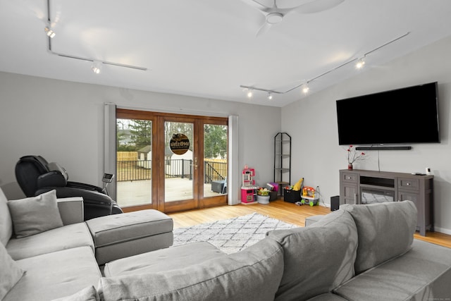 living area featuring wood finished floors and ceiling fan