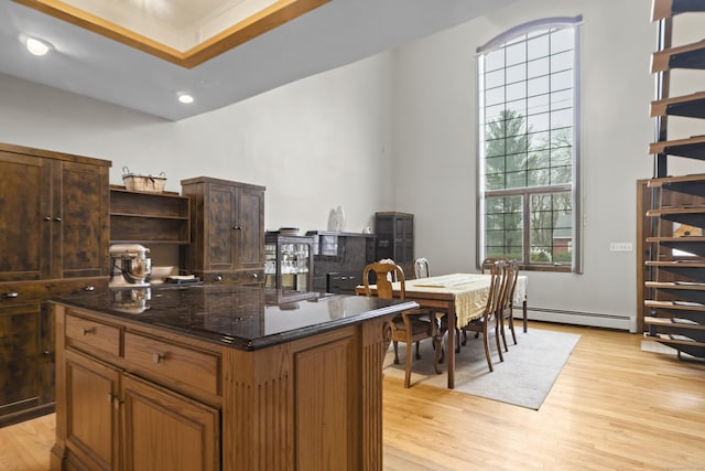 interior space with recessed lighting, baseboard heating, and light wood finished floors