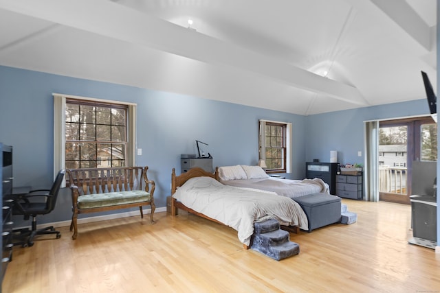 bedroom with access to outside, wood finished floors, baseboards, and vaulted ceiling