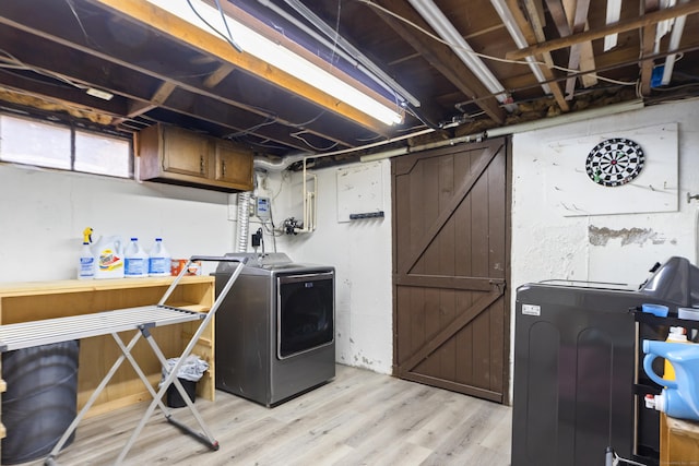 clothes washing area featuring laundry area, independent washer and dryer, and light wood-type flooring