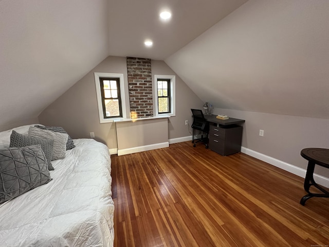 bedroom featuring lofted ceiling, baseboards, and wood-type flooring