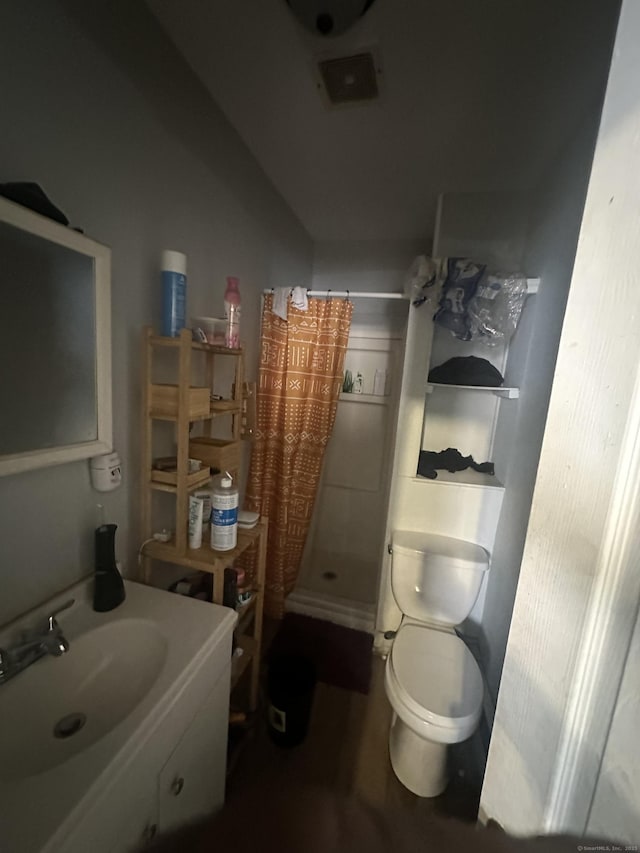 full bathroom with a shower stall, toilet, and a sink