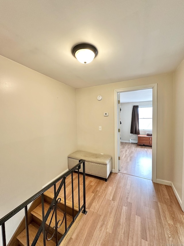 interior space featuring light wood finished floors, baseboards, and a baseboard radiator