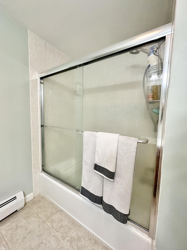 full bath with a baseboard heating unit, tile patterned floors, and combined bath / shower with glass door