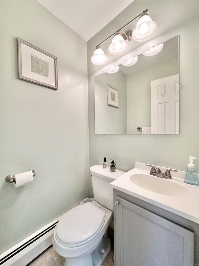 half bath with toilet, vanity, and a baseboard radiator