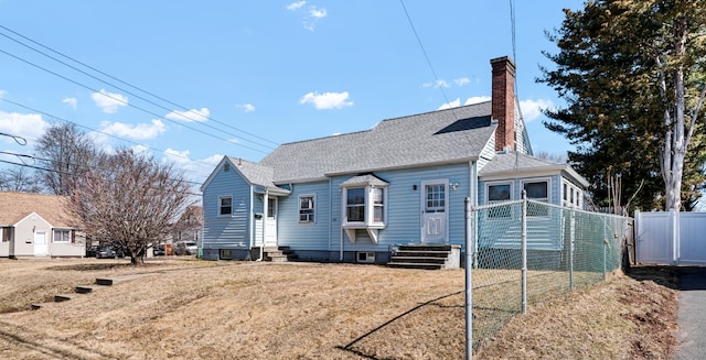 view of front of house with a shingled roof, a front lawn, fence, entry steps, and a chimney