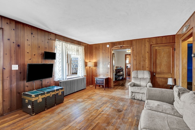 living room featuring radiator and hardwood / wood-style flooring