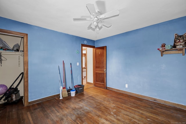 unfurnished bedroom with a ceiling fan, baseboards, and wood-type flooring