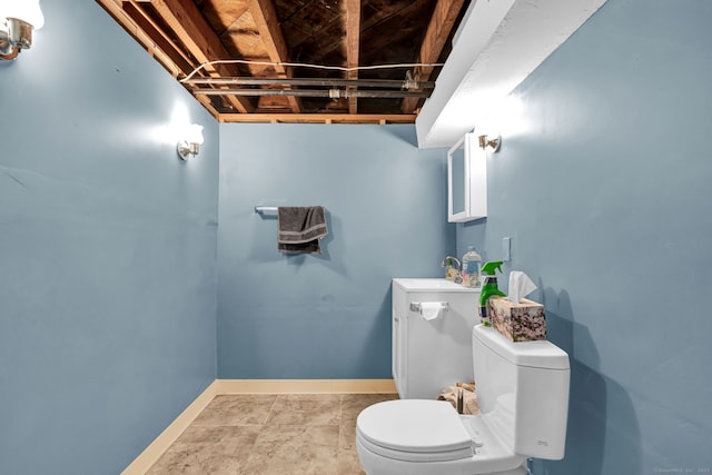 half bathroom featuring toilet, vanity, and baseboards