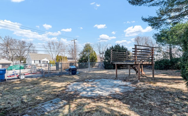 view of yard with a gate, a deck, and fence